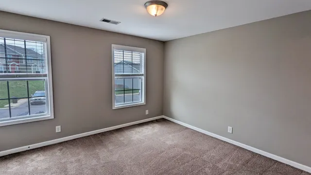 an empty room with windows and entrance