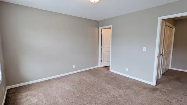 a view of an empty room and closet area