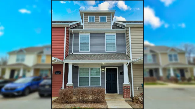 a view of a brick house with large windows