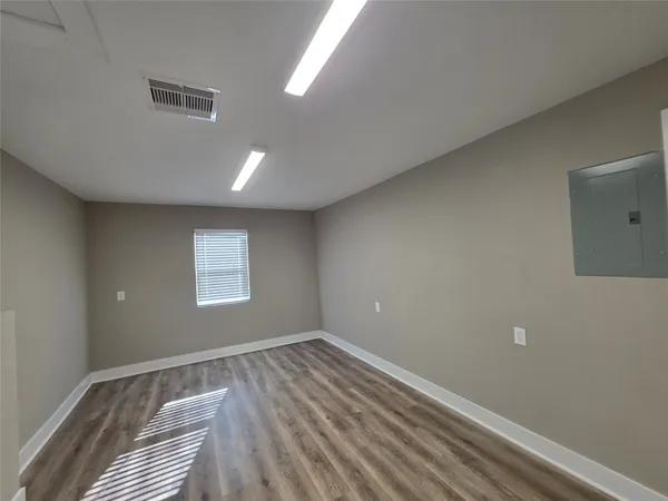 a view of room with window and hardwood floor