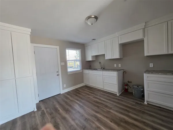 a kitchen with a refrigerator and window