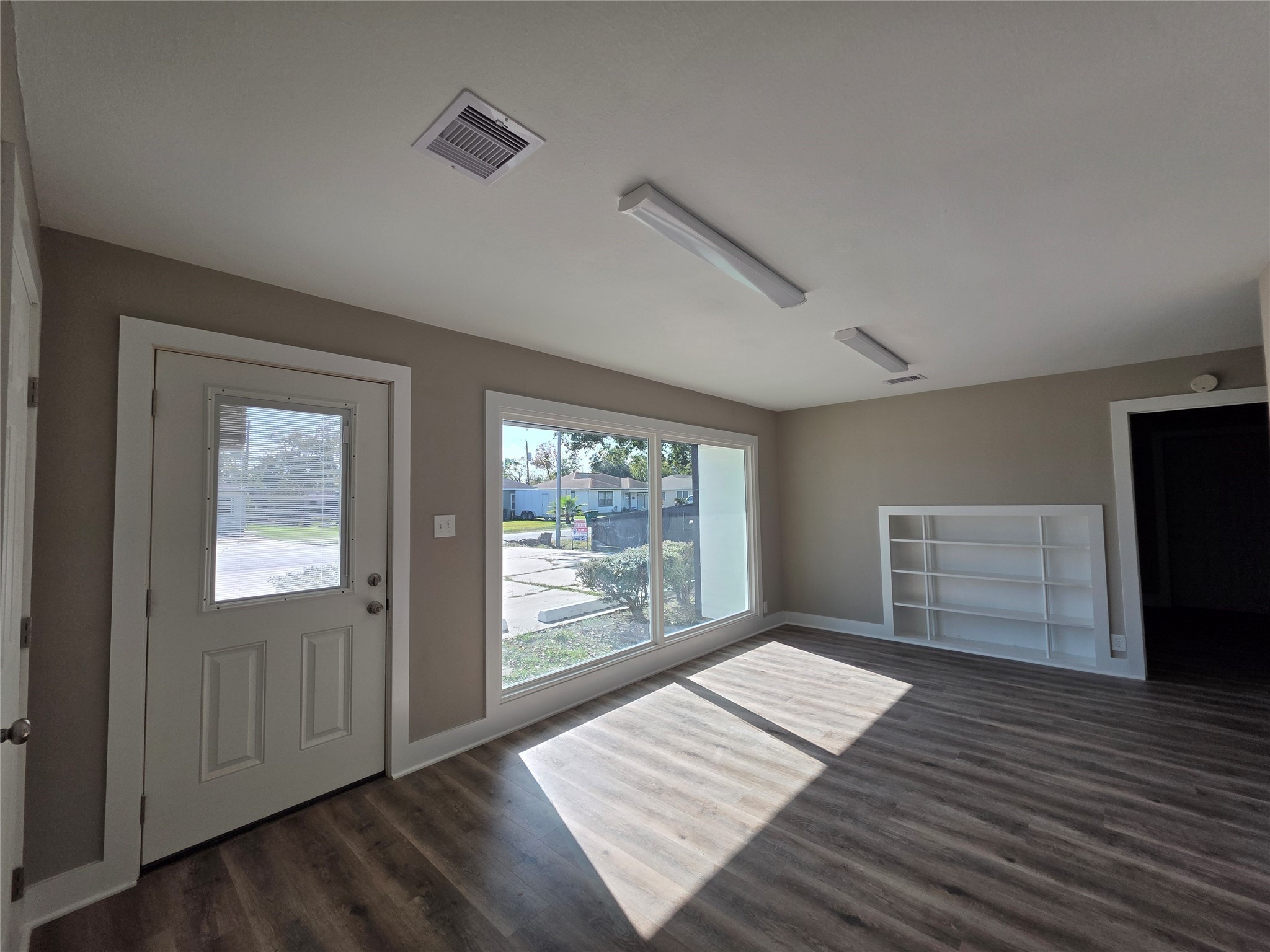 13379 Force Street Houston, TX 77015 - Photo 7 of 21 an empty room with wooden floor cabinet and windows