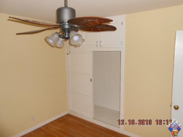 421 West Ave J 9 Lancaster, CA 93534 - Photo 5 of 7 a view of a hallway with wooden floor