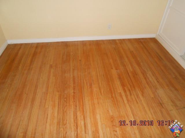 421 West Ave J 9 Lancaster, CA 93534 - Photo 6 of 7 a view of an empty room with wooden floor