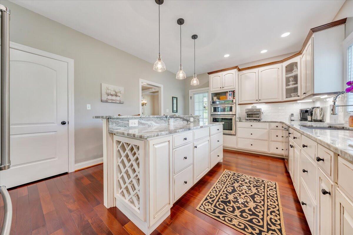 46 Claybrook Court Blue Ridge, VA 24064 - Photo 23 of 76 a kitchen with stainless steel appliances granite countertop a sink stove oven a refrigerator with white cabinets and wooden floor