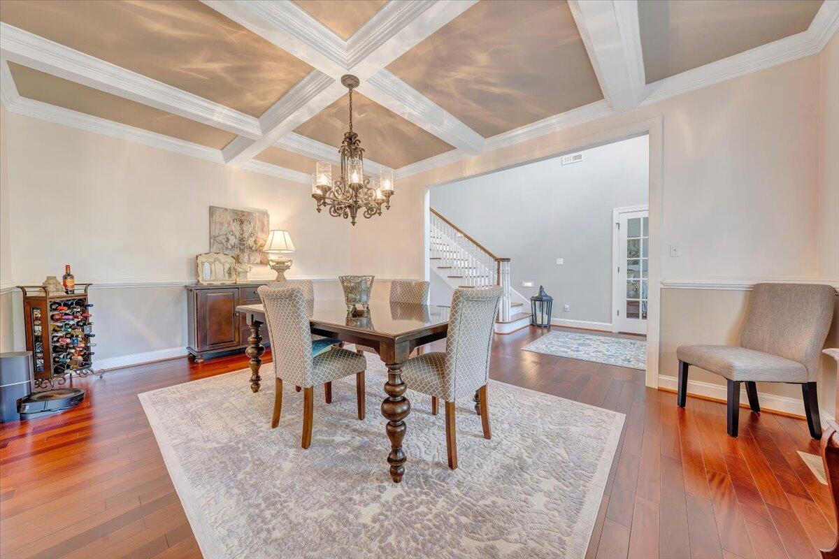 46 Claybrook Court Blue Ridge, VA 24064 - Photo 9 of 76 a dining room with wooden floor a chandelier a wooden table and chairs