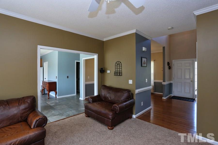 236 Hunters Farm Drive Raleigh, NC 27603 - Photo 2 of 21 a living room with a couch and a chandelier