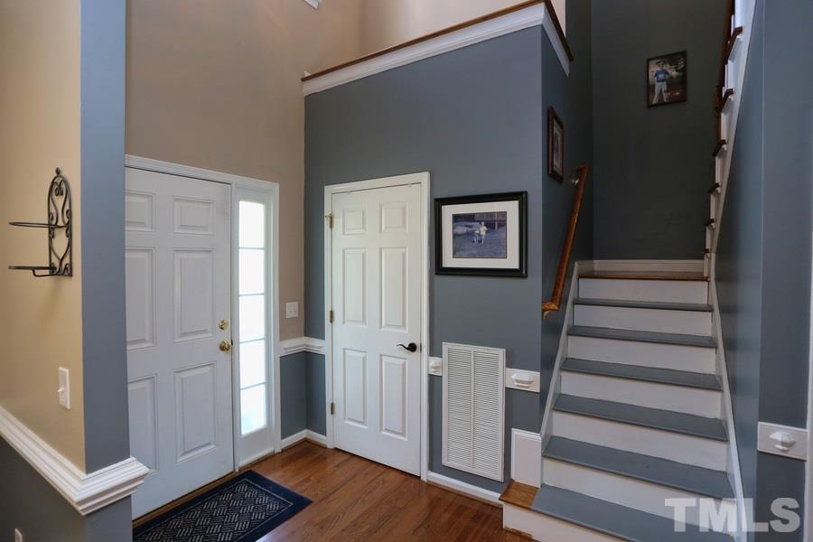 236 Hunters Farm Drive Raleigh, NC 27603 - Photo 11 of 21 a view of a hallway with wooden floor and staircase