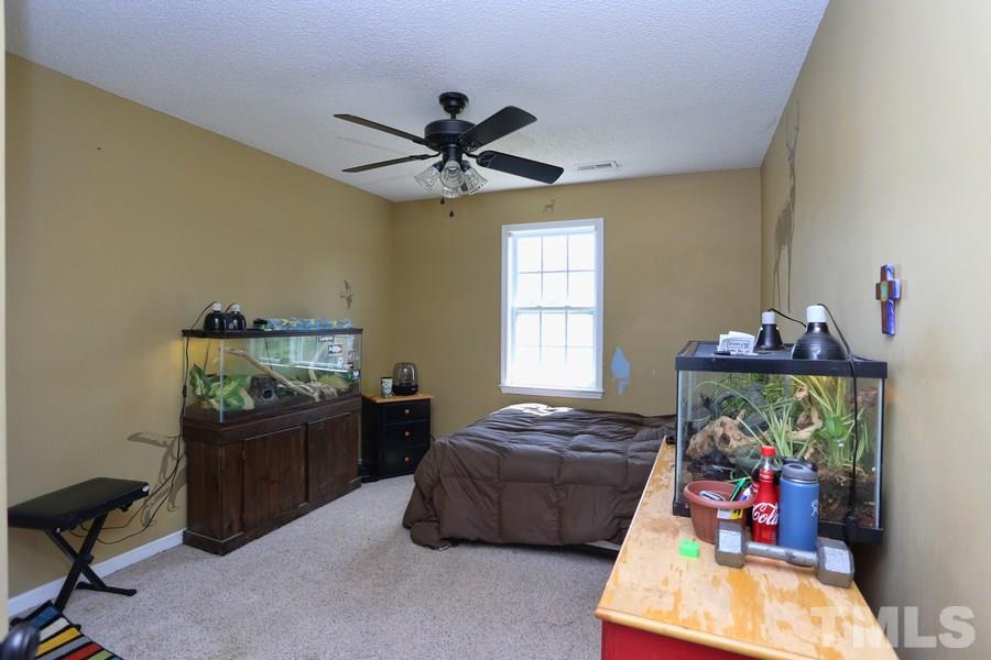 236 Hunters Farm Drive Raleigh, NC 27603 - Photo 14 of 21 a bedroom with a bed and a window