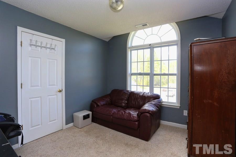 236 Hunters Farm Drive Raleigh, NC 27603 - Photo 16 of 21 a living room with furniture and a window