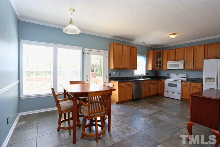 236 Hunters Farm Drive Raleigh, NC 27603 - Photo 5 of 21 a kitchen with a table chairs sink and cabinets