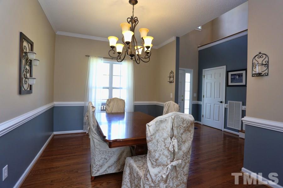 236 Hunters Farm Drive Raleigh, NC 27603 - Photo 9 of 21 a view of a dining room with furniture wooden floor and chandelier