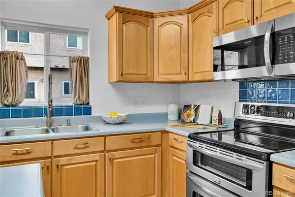a kitchen with stainless steel appliances granite countertop a sink stove and cabinets