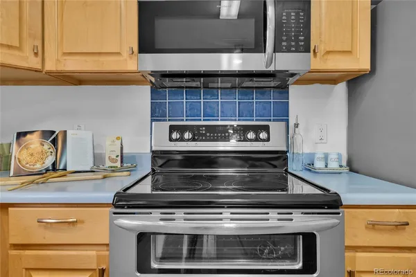 a stove top oven sitting inside of a kitchen