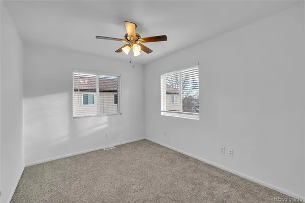a view of a livingroom with a ceiling fan and window