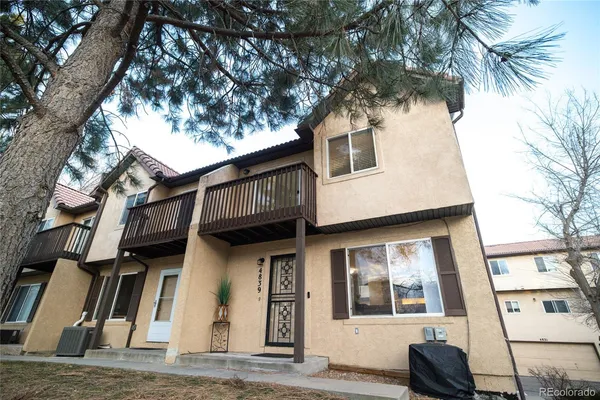 a view of a house with a tree