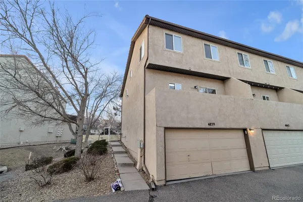 a view of a house with a large tree