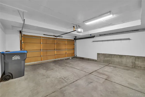 a view of a house with a tree and wooden fence