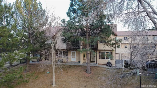 a view of a house with large trees