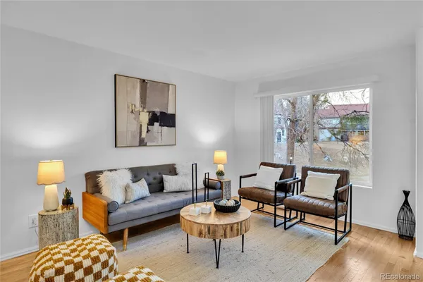 a living room with furniture and a lamp