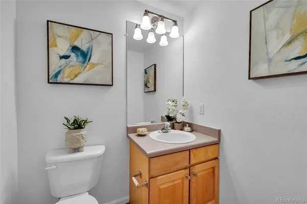 a bathroom with a sink mirror and toilet