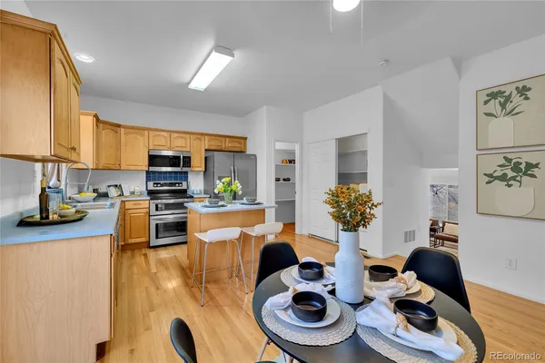 a kitchen with stainless steel appliances kitchen island granite countertop a sink and a stove