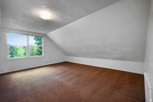 178 West 300 South Logan, UT 84321 - Photo 23 of 41 Bonus room featuring dark carpet and lofted ceiling