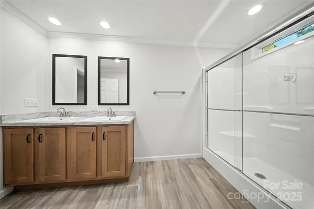 a bathroom with a granite countertop sink mirror and vanity