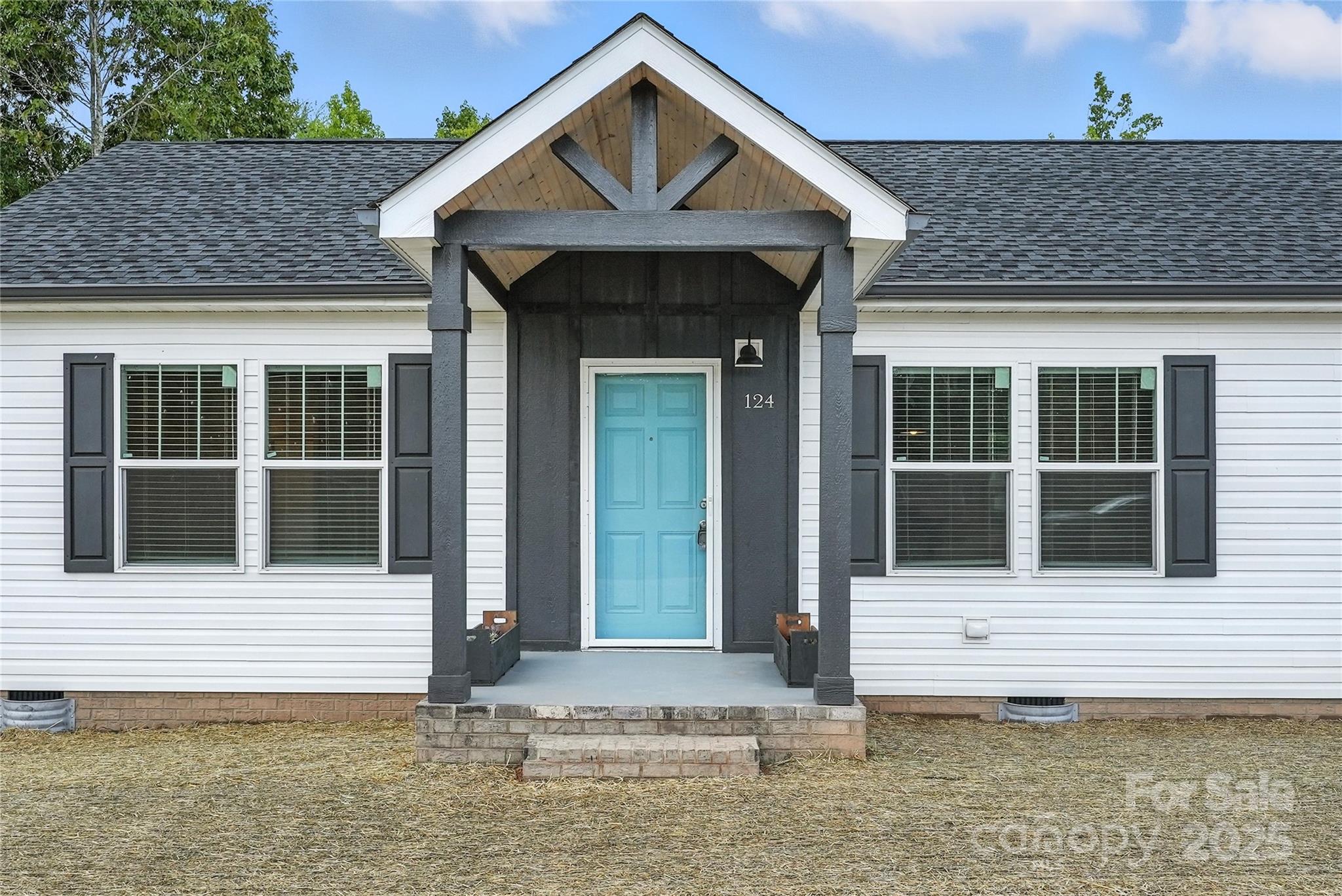 124 Dayton Road Dallas, NC 28034 - Photo 2 of 21 a front view of a house with a garden