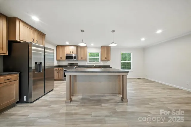 a kitchen with a refrigerator and a sink