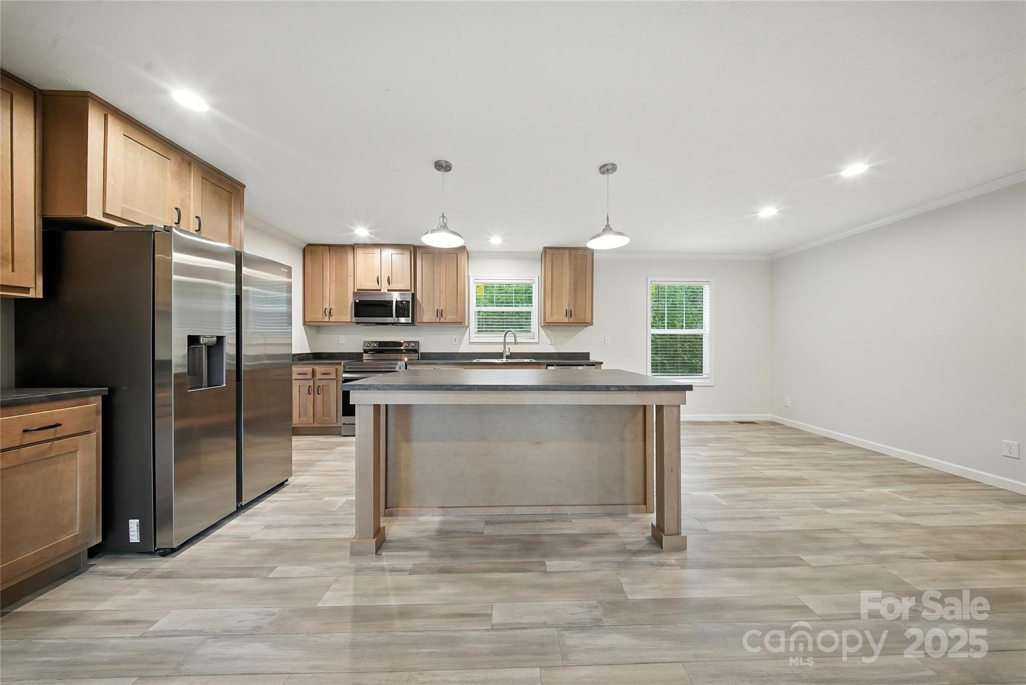 124 Dayton Road Dallas, NC 28034 - Photo 5 of 21 a kitchen with a refrigerator and a sink