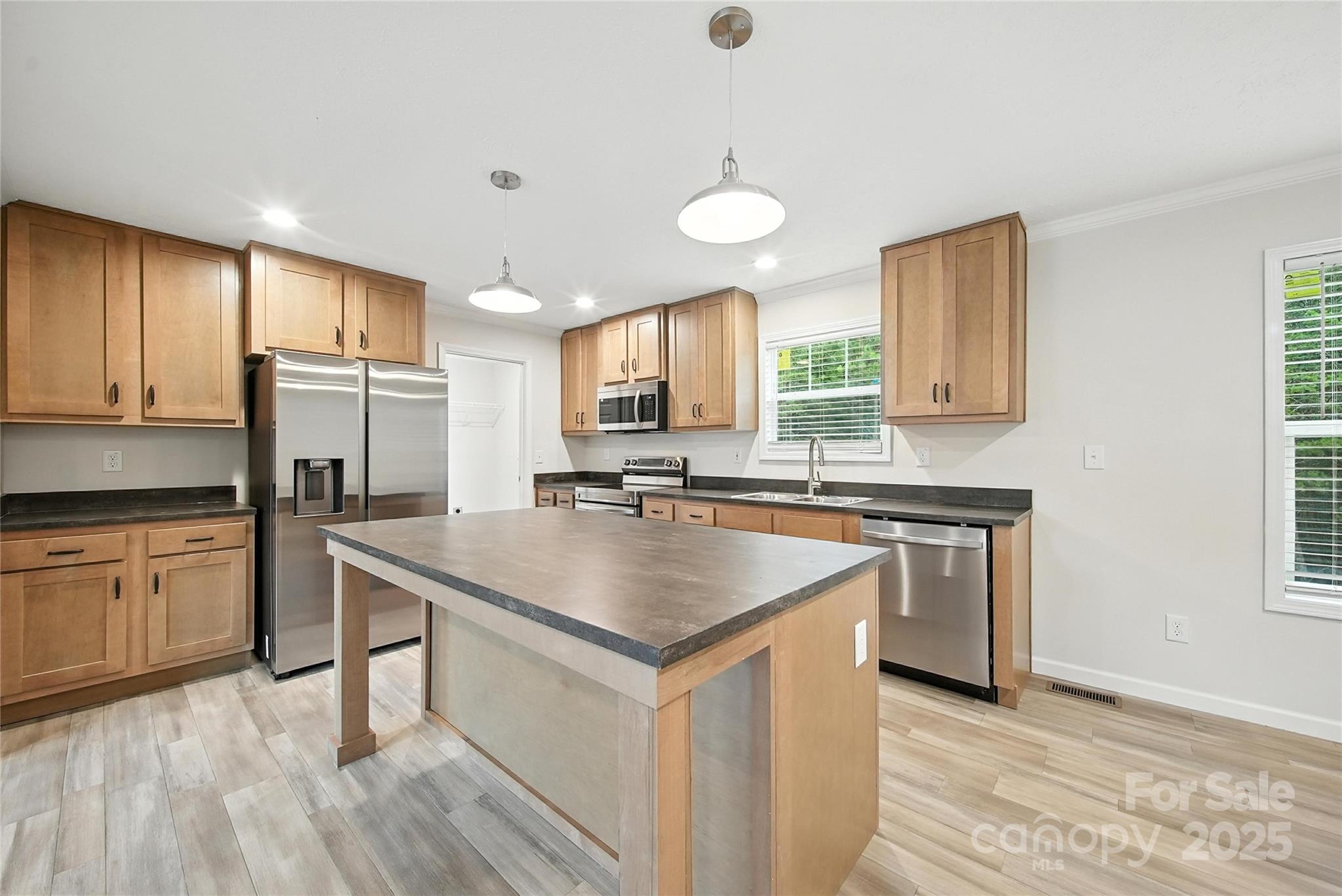 124 Dayton Road Dallas, NC 28034 - Photo 6 of 21 a kitchen with stainless steel appliances granite countertop a sink stove and refrigerator