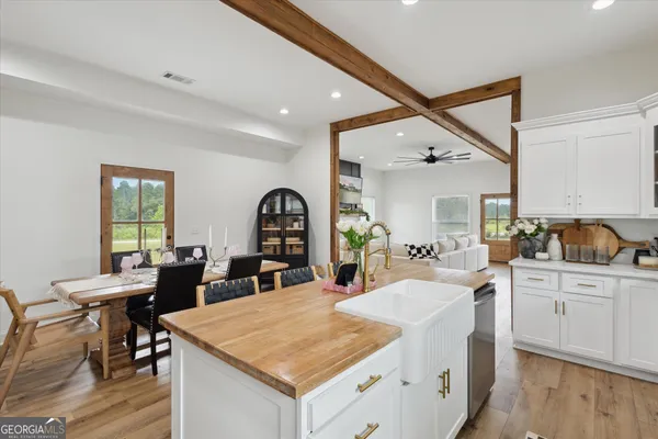 a kitchen that has a table and chairs in it