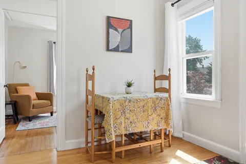 a large bed sitting in a bedroom next to a window
