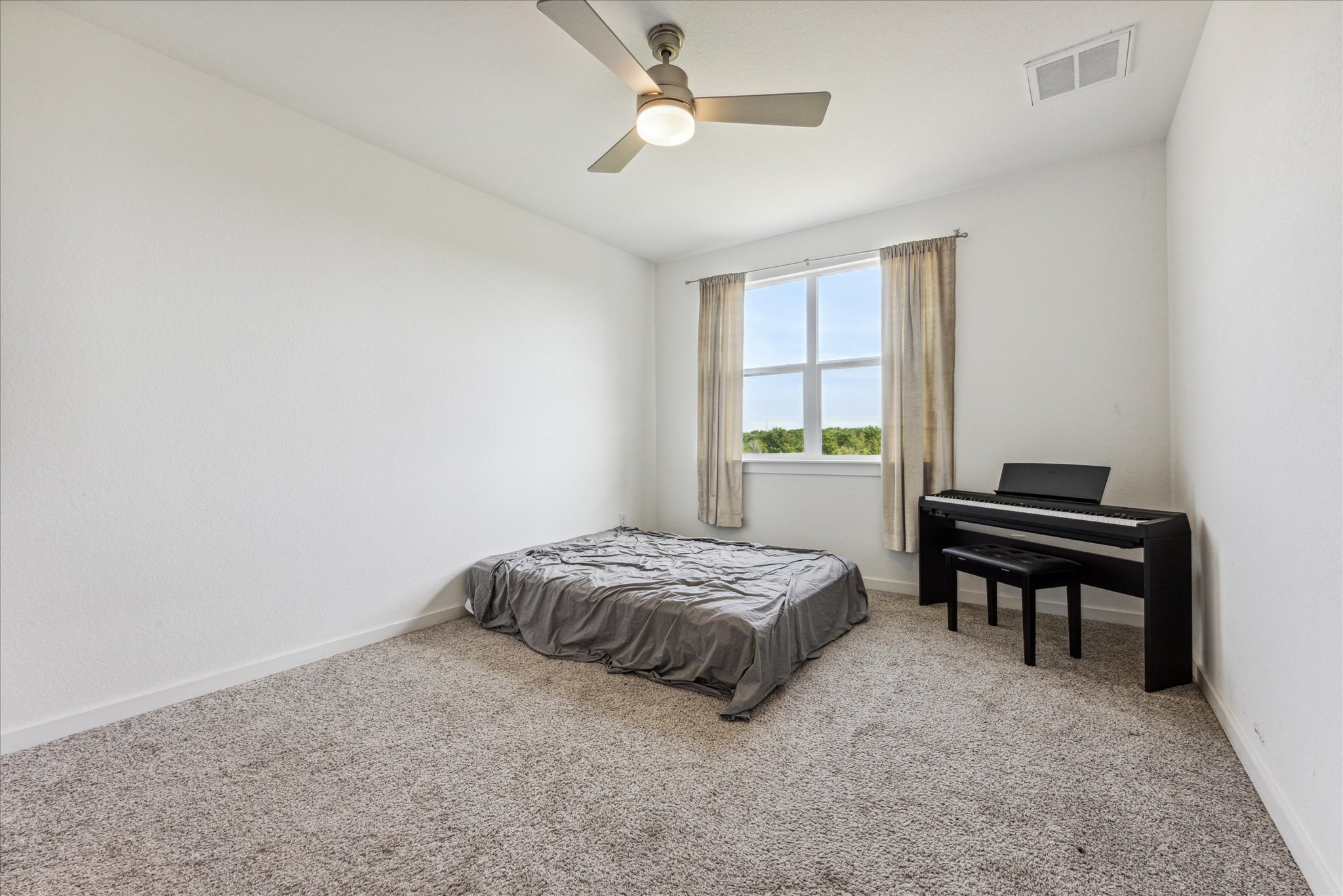 7916 Linnie Lane Austin, TX 78724 - Photo 10 of 14 a bedroom with a bed and a window