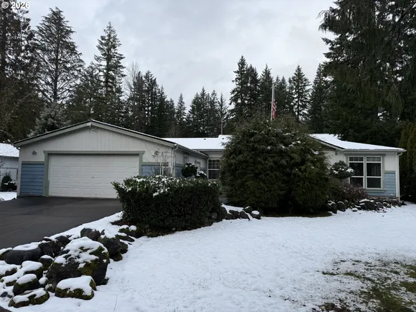 a front view of a house with a yard and trees