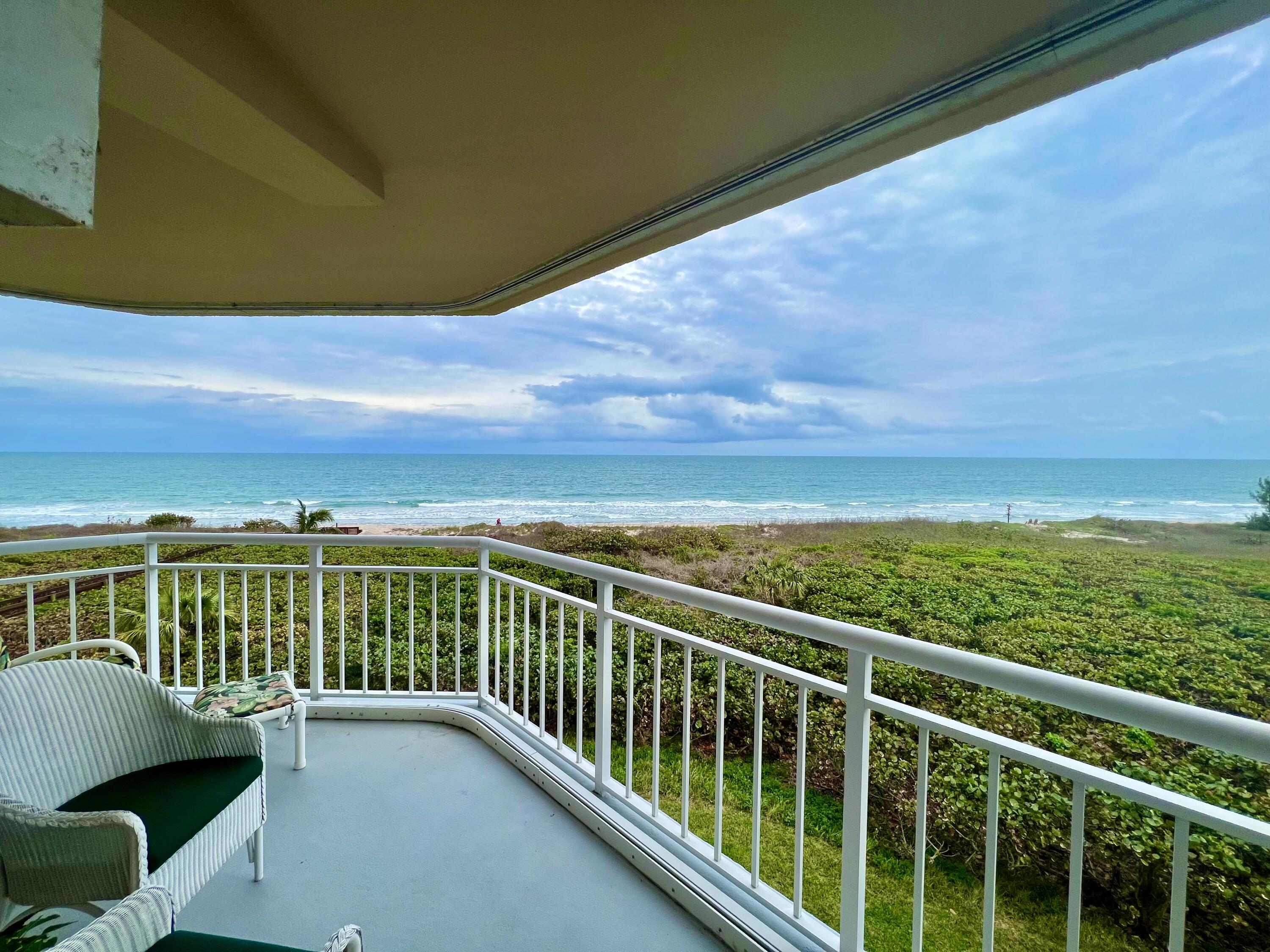 a view of a balcony with an ocean
