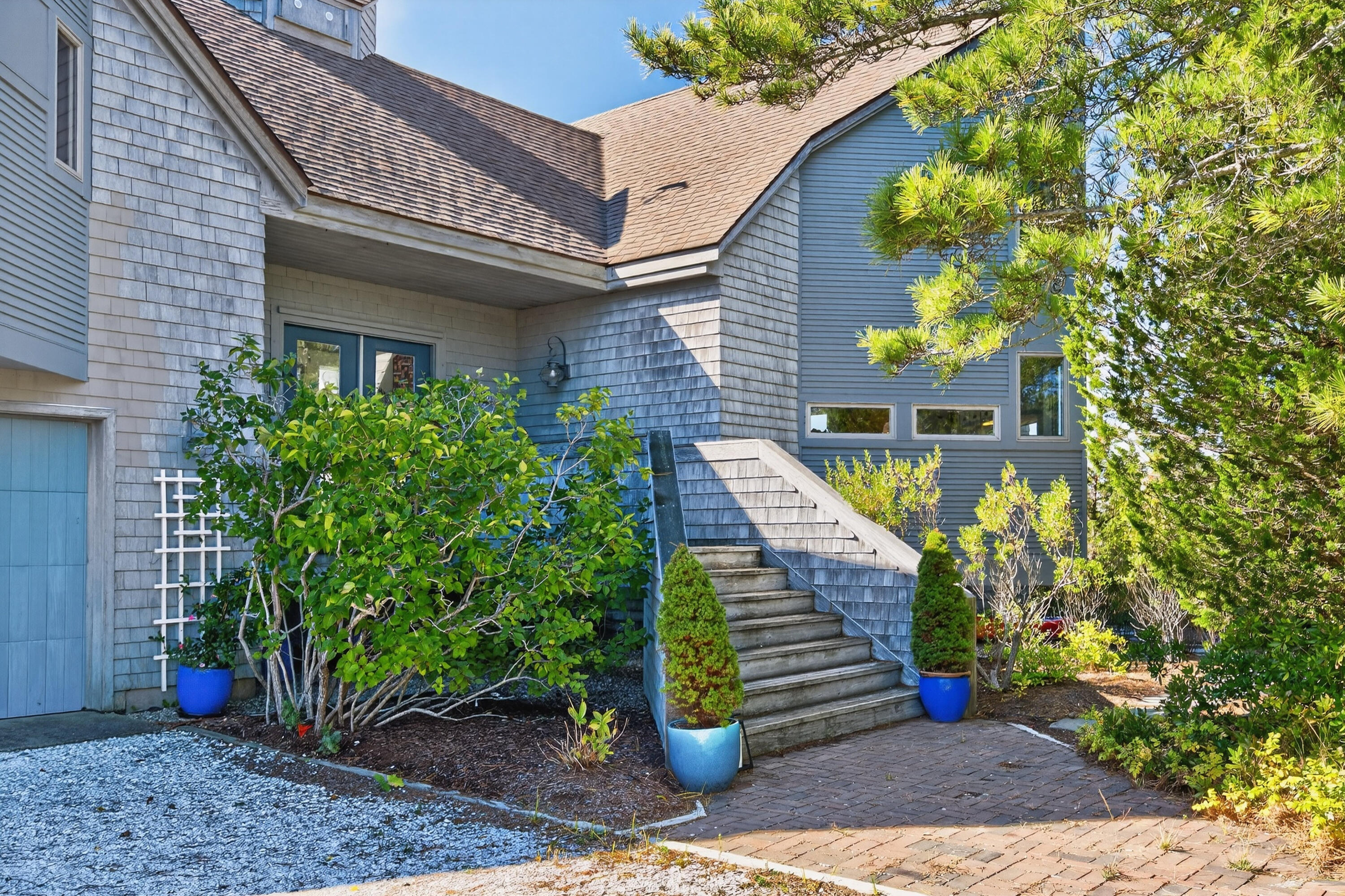 344 King Phillip Road Wellfleet, MA 02667 - Photo 12 of 72 a front view of a house with a garden