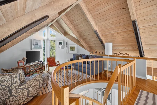 a view of balcony with wooden floor and fence