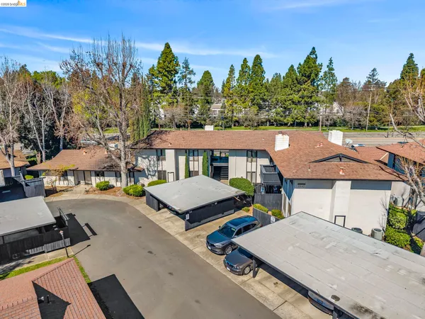 an aerial view of a house with swimming pool and outdoor seating