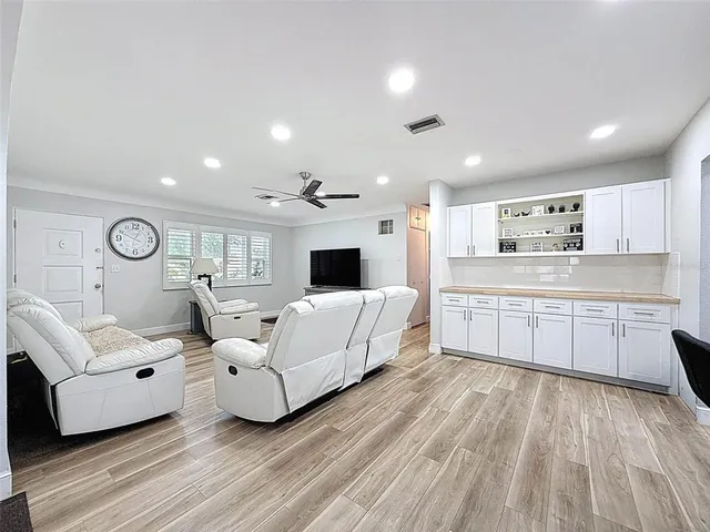 a kitchen with stainless steel appliances granite countertop a refrigerator and a stove top oven