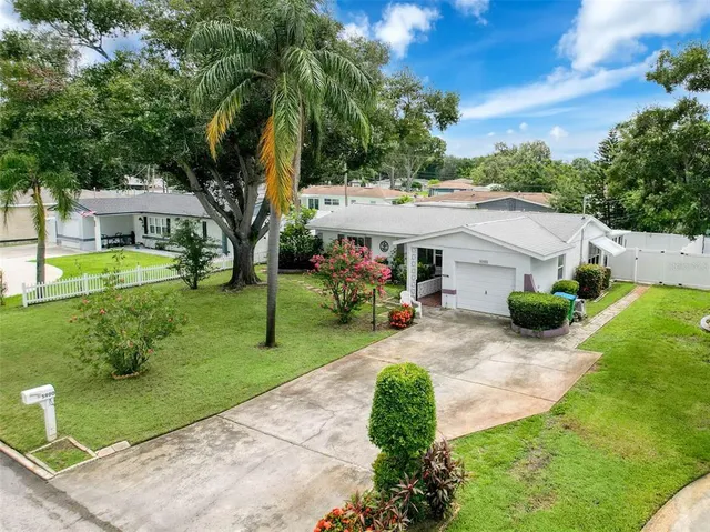 an aerial view of a house with a garden and swimming pool