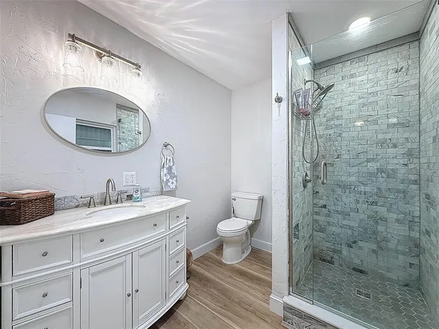 a view of a livingroom with furniture window and wooden floor