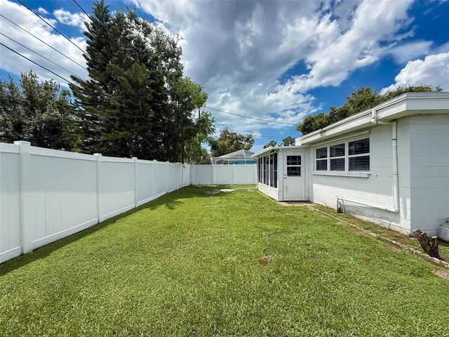 an aerial view of a house with a yard basket ball court and outdoor seating