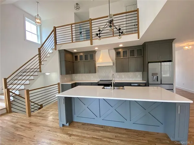 a kitchen with stainless steel appliances granite countertop a sink and a stove top oven