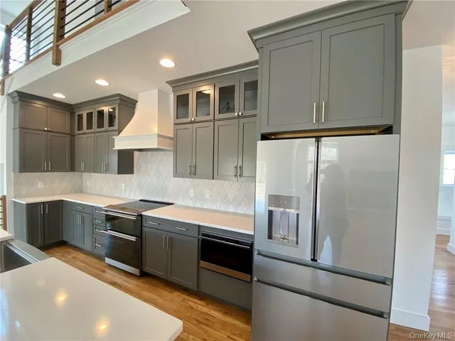 a spacious bathroom with a granite countertop sink and a large mirror