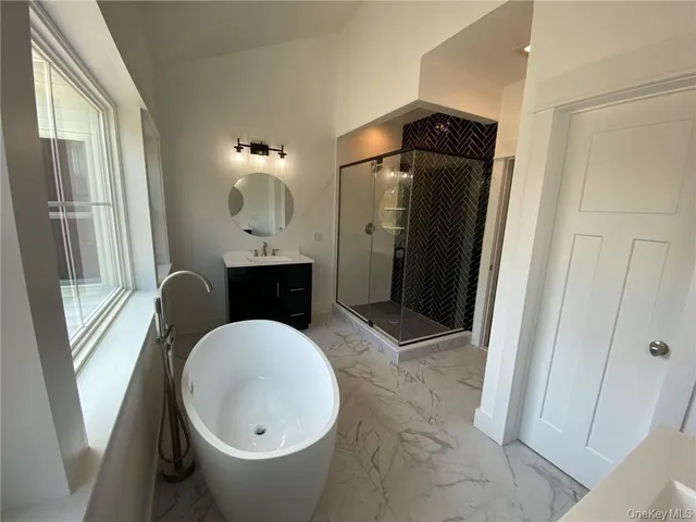 a bathroom with a sink mirror vanity and toilet