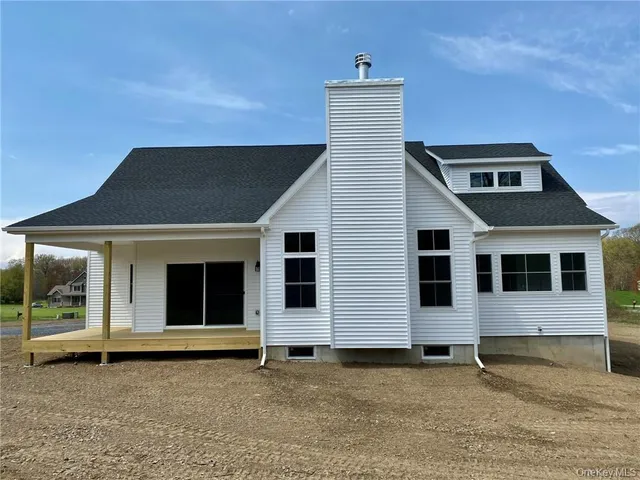 a view of a field with an trees in the background