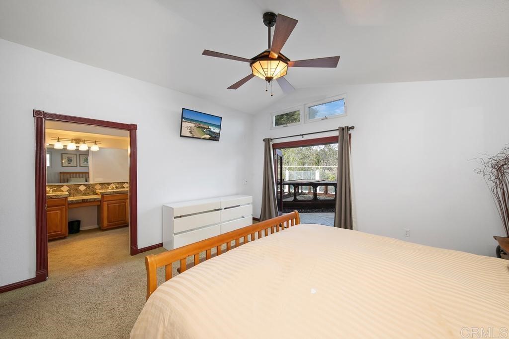 4730 Edinburgh Drive Carlsbad, CA 92010 - Photo 15 of 33 a bedroom with a bed and a chandelier