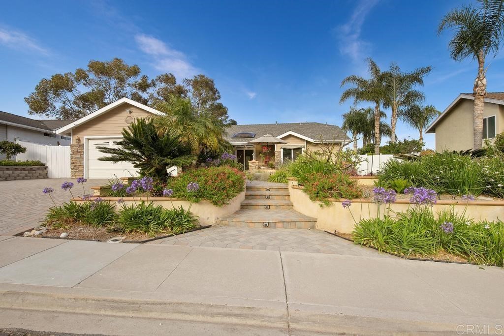 4730 Edinburgh Drive Carlsbad, CA 92010 - Photo 2 of 33 a front view of a house with a yard and potted plants